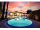 Backyard pool with a large spa and a beautiful twilight sky at 3597 Cochise Ln, Las Vegas, NV 89169