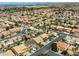 An aerial view highlights a real estate home in a neighborhood with desert landscaping and tiled roofs at 3692 River Canyon Rd, Las Vegas, NV 89129