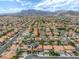 An aerial view highlights a home in a neighborhood set against a backdrop of mountains in a real estate context at 3692 River Canyon Rd, Las Vegas, NV 89129