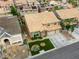 Aerial view of a meticulously landscaped home featuring a tiled roof, three-car garage, and well-kept lawn at 3692 River Canyon Rd, Las Vegas, NV 89129