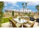 Relaxing backyard featuring a dining set, well-maintained artificial grass, and an inviting pool at 3692 River Canyon Rd, Las Vegas, NV 89129