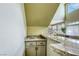 Entertain in style with this wet bar featuring granite counters and sink at 3692 River Canyon Rd, Las Vegas, NV 89129