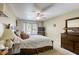 Comfortable bedroom with ceiling fan, carpet and a view to the outside at 3692 River Canyon Rd, Las Vegas, NV 89129