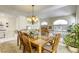 Elegant dining area with high ceilings, a chandelier, and ample natural light at 3692 River Canyon Rd, Las Vegas, NV 89129