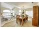Cozy dining area featuring a wooden table, chandelier, and natural light at 3692 River Canyon Rd, Las Vegas, NV 89129