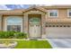 Elegant entryway with double doors, stone pillars, and manicured landscaping at 3692 River Canyon Rd, Las Vegas, NV 89129