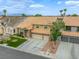 Well-maintained home showcasing a tiled roof, three-car garage, and landscaped front yard at 3692 River Canyon Rd, Las Vegas, NV 89129