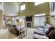 Open concept living room with high ceilings, a fireplace, and a view into the kitchen at 3692 River Canyon Rd, Las Vegas, NV 89129