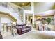 Living room featuring high ceilings, staircase, and view of kitchen at 3692 River Canyon Rd, Las Vegas, NV 89129