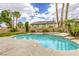 Captivating pool and spa with serene waterfall feature, surrounded by lush landscaping and patio area at 3692 River Canyon Rd, Las Vegas, NV 89129