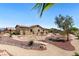 Expansive backyard with desert landscaping and a rock garden design under a clear blue sky at 4317 Velvet Ridge Ct, Las Vegas, NV 89129