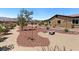 Beautifully landscaped backyard with mature trees, desert landscaping, and serene seating area at 4317 Velvet Ridge Ct, Las Vegas, NV 89129