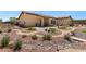 Serene backyard with desert landscaping, a stone patio, and outdoor seating on a sunny day at 4317 Velvet Ridge Ct, Las Vegas, NV 89129