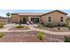 Inviting backyard with desert landscaping, a stone patio, and outdoor seating on a sunny day at 4317 Velvet Ridge Ct, Las Vegas, NV 89129