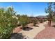 Manicured walkway lined with colorful flowering bushes adding charm to this backyard at 4317 Velvet Ridge Ct, Las Vegas, NV 89129