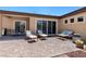 Cozy stone patio with a seating area and desert landscaping on a sunny day at 4317 Velvet Ridge Ct, Las Vegas, NV 89129