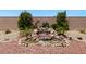 Scenic backyard displaying a rock waterfall feature, garden, and privacy wall at 4317 Velvet Ridge Ct, Las Vegas, NV 89129