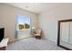 Bright bedroom with carpet, a large window, and a vintage-style chair at 4317 Velvet Ridge Ct, Las Vegas, NV 89129