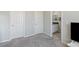 Bedroom with gray carpet, two closets, and a bathroom entrance at 4317 Velvet Ridge Ct, Las Vegas, NV 89129