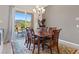 Dining room with wood table, seating for six, chandelier, and sliding glass door to backyard at 4317 Velvet Ridge Ct, Las Vegas, NV 89129
