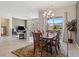 Open concept living and dining area with wood table, seating for six, and sliding glass door to backyard at 4317 Velvet Ridge Ct, Las Vegas, NV 89129