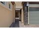 View of a gated walkway leading to the front of a home with tan stucco and stone accents at 4317 Velvet Ridge Ct, Las Vegas, NV 89129
