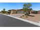 Lovely single-story home with desert landscaping and a two-car garage on a sunny day at 4317 Velvet Ridge Ct, Las Vegas, NV 89129
