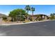Street view of a single-story home with desert landscaping, brick wall, and palm trees at 4317 Velvet Ridge Ct, Las Vegas, NV 89129