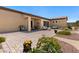 Charming backyard patio with brick pavers, a grill, seating, and a lush garden at 4317 Velvet Ridge Ct, Las Vegas, NV 89129