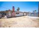 View of the home's backyard with shed and brick chimney at 4516 E Flamingo Rd, Las Vegas, NV 89121
