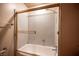 Bathroom featuring a shower and tub with glass doors and tile walls at 4516 E Flamingo Rd, Las Vegas, NV 89121