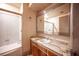 Bathroom featuring a vanity with marble top, a large mirror, and a shower with glass doors at 4516 E Flamingo Rd, Las Vegas, NV 89121