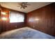 Bedroom showcasing wood-paneled walls, carpet, and a window at 4516 E Flamingo Rd, Las Vegas, NV 89121