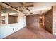 View of the home's entryway with tile floors, brick accent wall and ceiling fan at 4516 E Flamingo Rd, Las Vegas, NV 89121