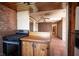 View of the kitchen area with gas range, wood cabinets and tile floor at 4516 E Flamingo Rd, Las Vegas, NV 89121