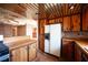 Traditional kitchen featuring wood cabinets and a white refrigerator at 4516 E Flamingo Rd, Las Vegas, NV 89121