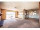 Spacious living room featuring a large window, neutral walls, and tile flooring adjacent to the carpeted area at 4516 E Flamingo Rd, Las Vegas, NV 89121