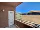 Small outdoor patio with storage closet and wrought iron fence in front of neighboring houses at 4730 E Craig Rd # 1005, Las Vegas, NV 89115