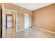 Neutral bedroom with tile floors, closet, and view of a washer and dryer behind the doorway at 4730 E Craig Rd # 1005, Las Vegas, NV 89115