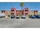 Apartment complex with palm trees and ample parking under a clear blue sky at 4730 E Craig Rd # 1005, Las Vegas, NV 89115