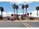 Striking exterior view of a community building, framed by tall palm trees and set against a vibrant blue sky at 4730 E Craig Rd # 1005, Las Vegas, NV 89115