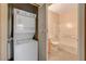 Washer and Dryer in hall next to neutral bathroom with white tiled shower and wood vanity at 4730 E Craig Rd # 1005, Las Vegas, NV 89115