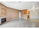 Open living room with tiled flooring, fireplace, and open view into kitchen at 4730 E Craig Rd # 1005, Las Vegas, NV 89115