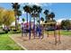 A community playground with a variety of play equipment and tall, mature palm trees at 4730 E Craig Rd # 1005, Las Vegas, NV 89115