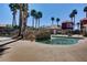 Outdoor community pool area with palm trees, stone accents, and a tranquil water feature at 4730 E Craig Rd # 1005, Las Vegas, NV 89115