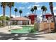 A community pool area surrounded by palm trees, stairs, and lush landscaping at 4730 E Craig Rd # 1005, Las Vegas, NV 89115