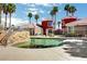 Community pool with palm trees, a stone wall and stairs, providing a serene recreational space at 4730 E Craig Rd # 1005, Las Vegas, NV 89115