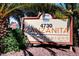 Community sign displaying address and complex name, nestled among lush trees and foliage at 4730 E Craig Rd # 1005, Las Vegas, NV 89115