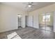 Bright bedroom with gray wood floors, a ceiling fan, and a mirrored closet at 4801 Stoneham, Pahrump, NV 89061