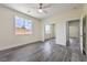 Bright bedroom featuring hardwood floors, natural light, and a mirrored closet at 4801 Stoneham, Pahrump, NV 89061